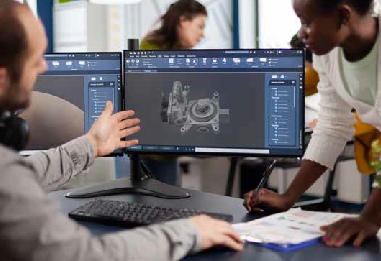 a tech gestures at a replacement part schematic on a large computer monitor